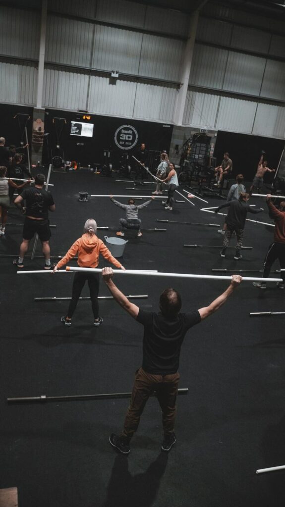 A class of CrossFit beginners learning to do a snatch