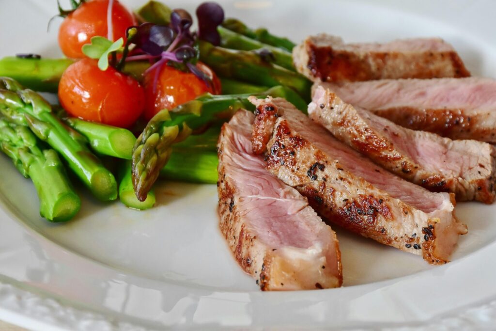 A meal with steak and vegetables. Steak is a rich protein source used for CrossFit nutrition