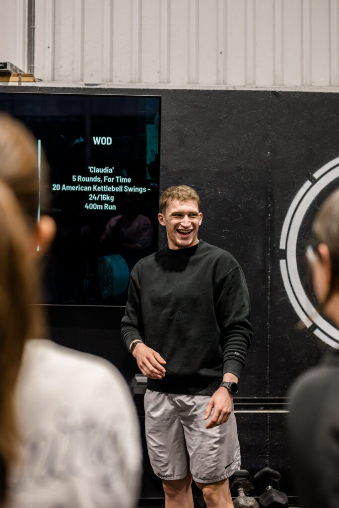 A CrossFit coach talking to members about their CrossFit transformation